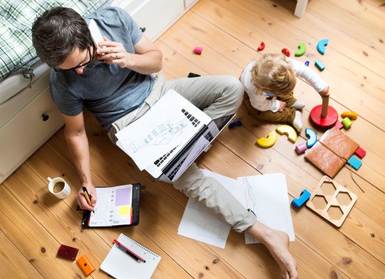 Father with his little son working from home