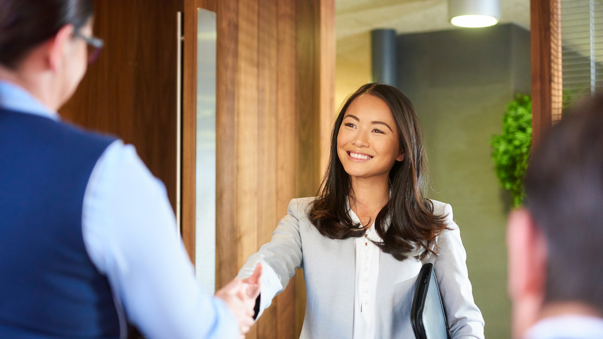 Business woman shaking hands with hiring manager