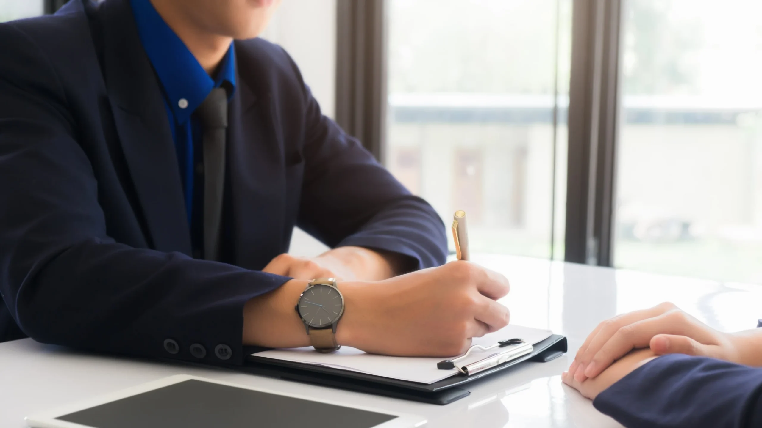hiring manager writing on clipboard